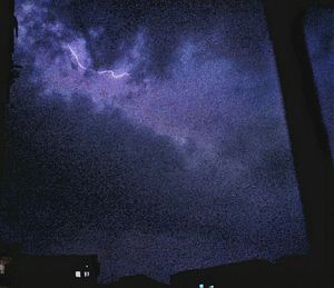 Low angle view of illuminated building against sky