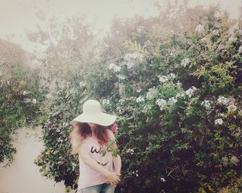 Woman standing on tree trunk