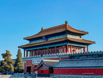 Low angle view of building against clear blue sky