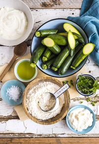 Directly above shot of zucchinis and flour on table