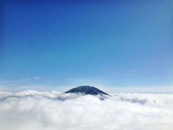 Scenic view of mountains against cloudy sky