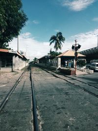 Railroad track against cloudy sky