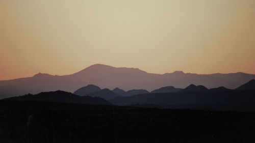 Scenic view of silhouette mountains against sky during sunset