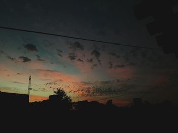 Scenic view of silhouette city against sky at sunset