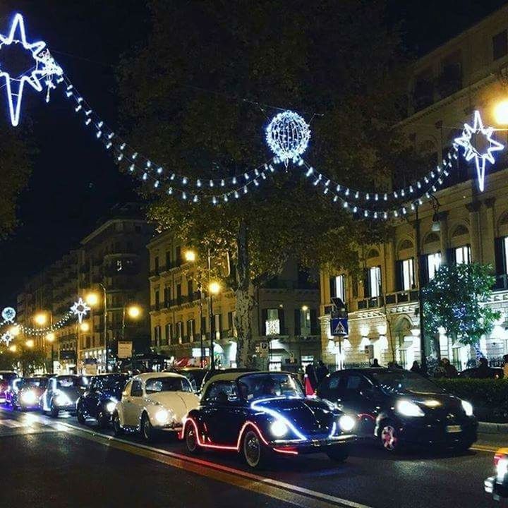 illuminated, car, land vehicle, night, architecture, transportation, built structure, building exterior, mode of transport, street, city, street light, road, incidental people, lighting equipment, city life, city street, traffic, travel, parking