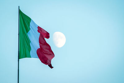 Low angle view of italian flag against clear blue sky