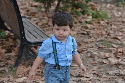 Cute boy playing at public park during autumn