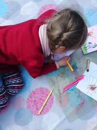 High angle view of girl sitting on floor