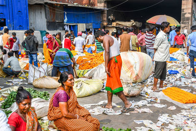 People working at market stall in city