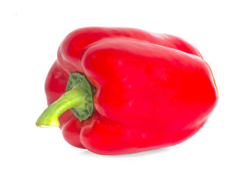 Close-up of red bell peppers against white background