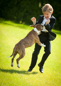 View of boy playing with dog