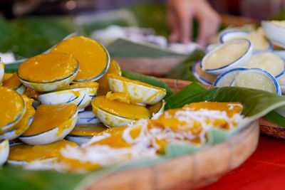 Close-up of hand holding fruits on table