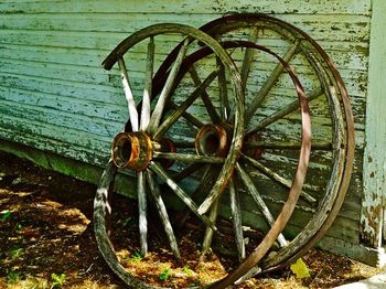 Abandoned wheels by wooden wall