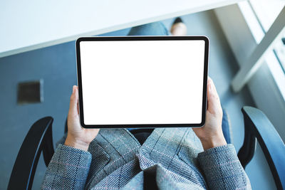 Midsection of woman using digital tablet