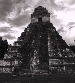 Low angle view of historical building against cloudy sky