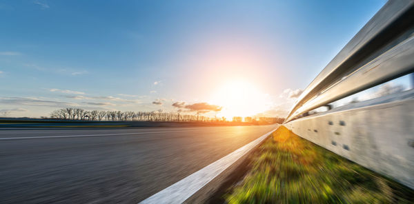 Blurred motion of car against sky during sunset