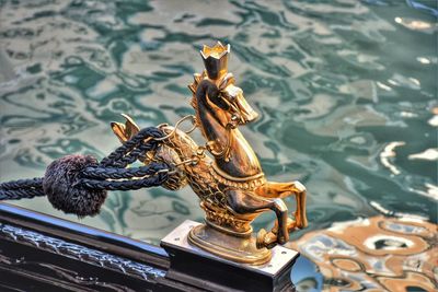 Close-up of buddha statue by water