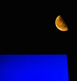 Low angle view of moon against sky at night