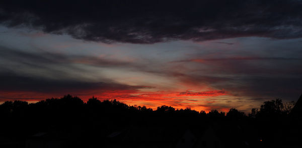 Silhouette of landscape against cloudy sky