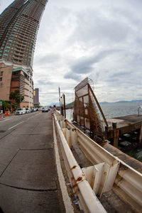 Panoramic view of city street and buildings against sky