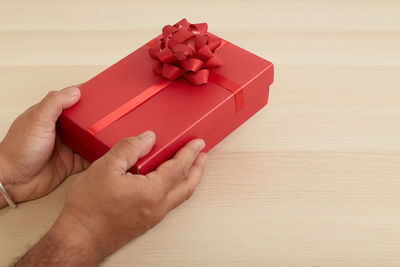 Close-up of hand holding red table