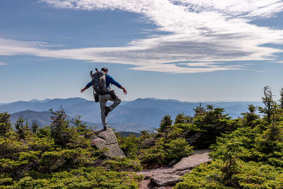 Man standing by mountain against sky