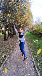 Full length portrait of happy young woman