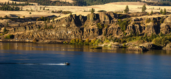 Boat in lake against landscape