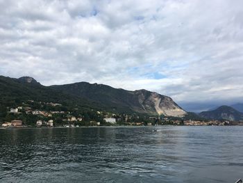 Scenic view of lake by mountains against sky