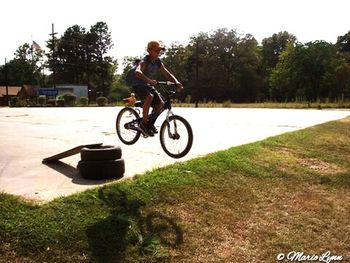 People riding motorcycle on grass