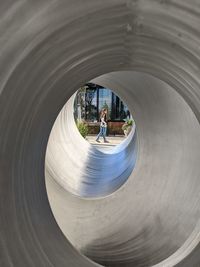 Woman walking in the distance surrounded by metal