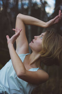 Young woman dancing in forest