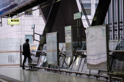 Man standing on railroad station platform