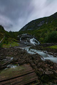 Scenic view of waterfall against sky