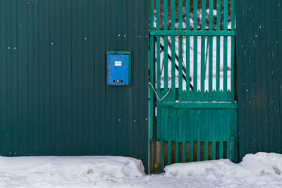 Closed blue gate during winter