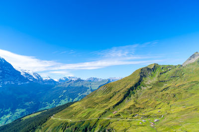 Scenic view of mountains against blue sky