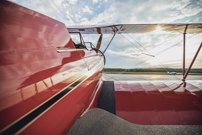 Red vintage antique waco biplane at airport in maine at sunrise