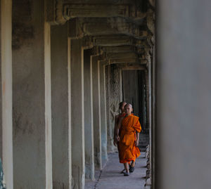 Monks walking in corridor of temple