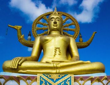 Low angle view of statue against blue sky