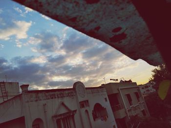 Low angle view of buildings against sky during sunset