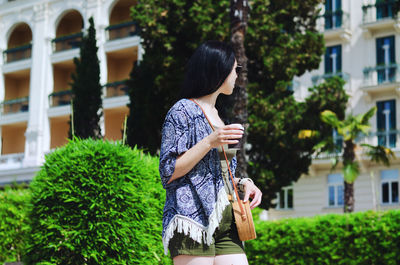 Young happy business woman relaxing in city, outdoor cafe. drinking coffee. using phone. summer