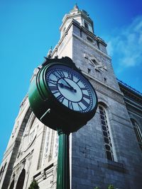 Low angle view of clock tower against sky