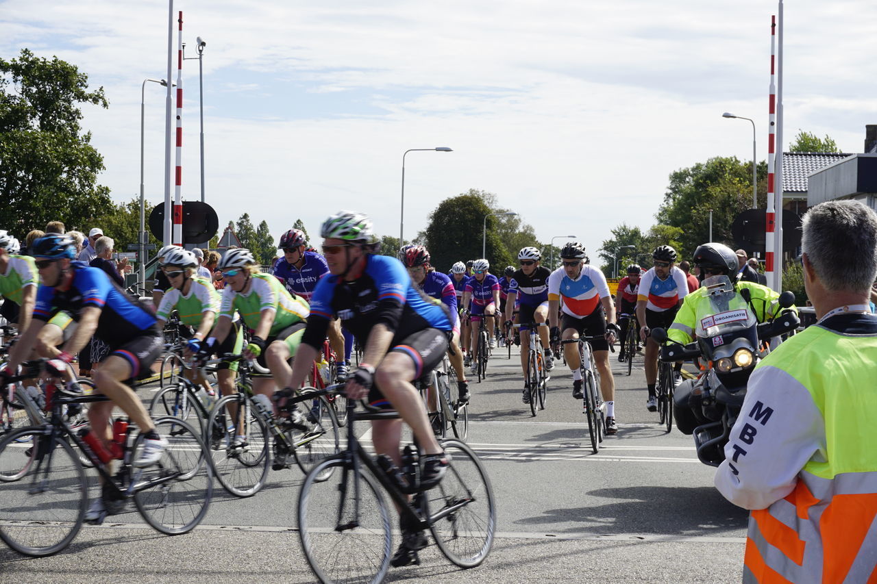 PEOPLE RIDING BICYCLE ON ROAD