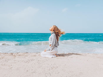 Full length of woman on beach against sky