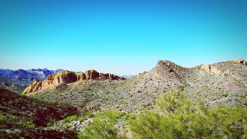 Scenic view of rocky mountains against clear blue sky