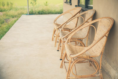 Empty chairs and table against wall