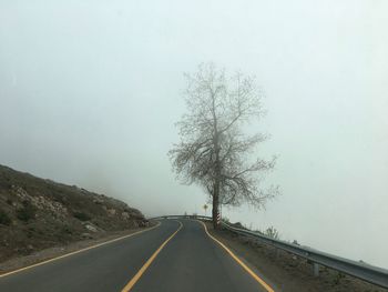 Empty road along countryside landscape