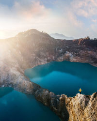 High angle view of lake and mountains against sky