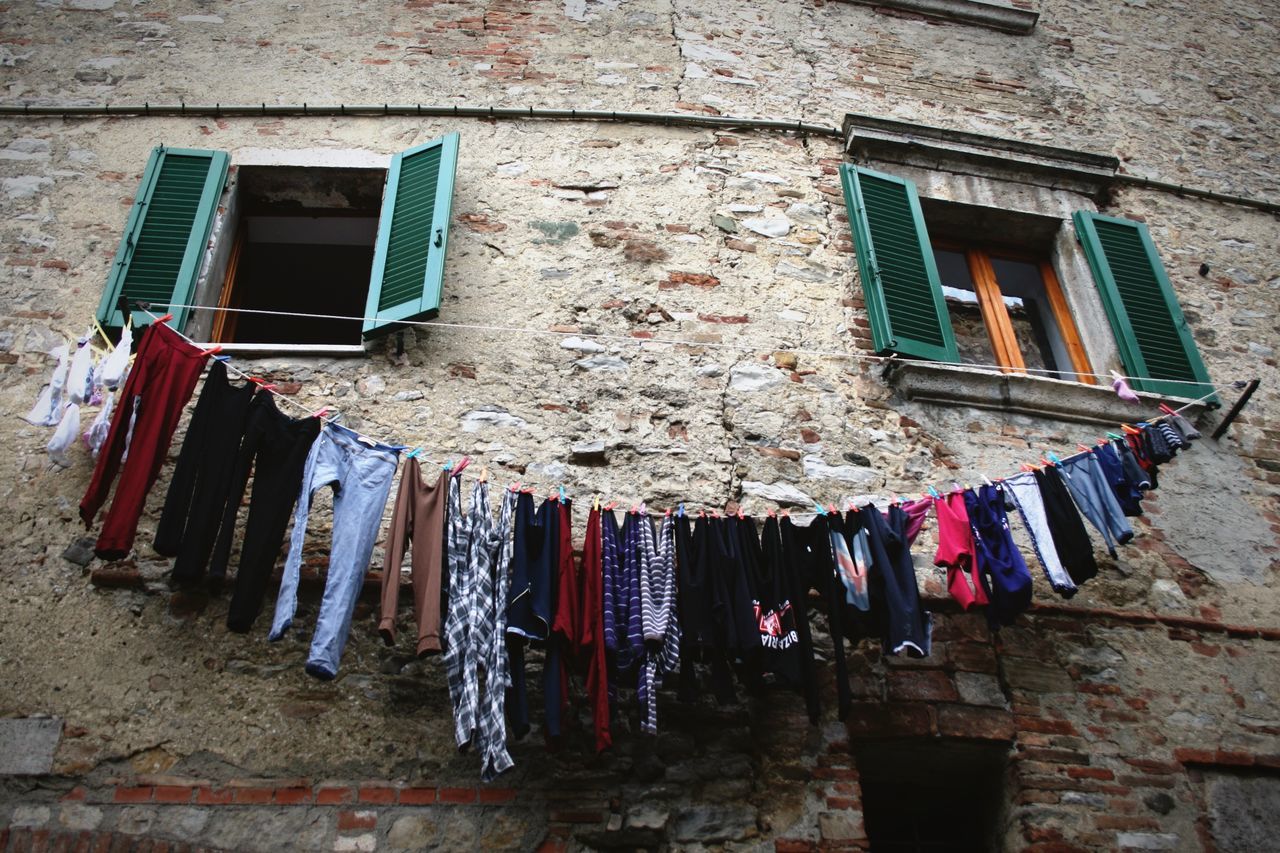 hanging, drying, clothesline, laundry, clothing, low angle view, building exterior, built structure, architecture, window, clothes, outdoors, no people, day, chores