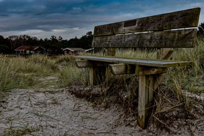 Abandoned house on field against sky